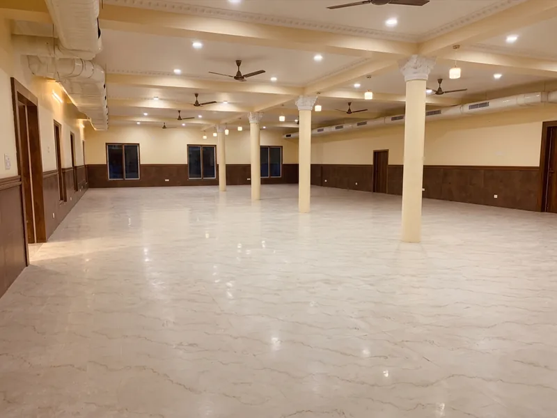 Dining hall at SLNT Mahal wedding venue in Thiruparankundram, with tiled floors and pillars
