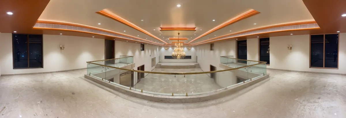 Main marriage hall interior at SLNT Mahal with chandeliers and wedding stage