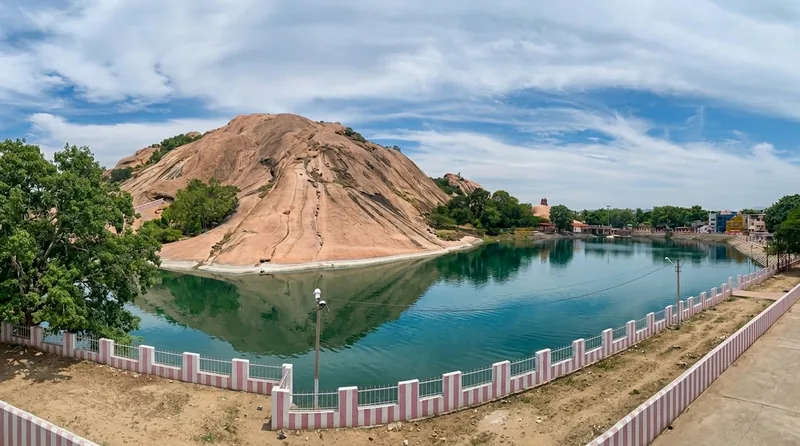 Saravana Poigai temple tank reflecting Thiruparankundram Hill